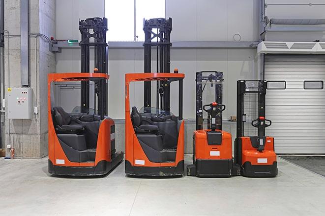 forklifts carrying containers at a shipping port